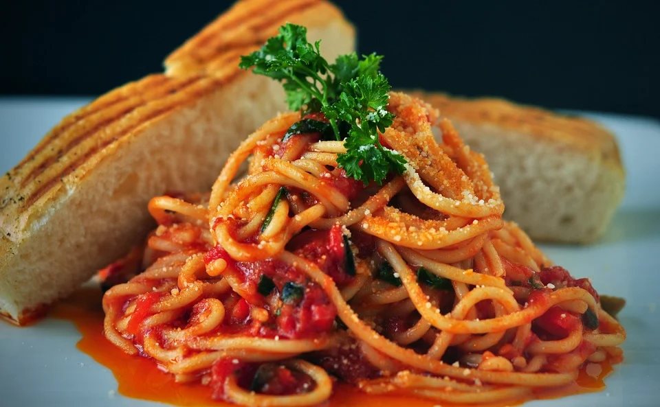 Close up of a dinner plate of delicious-looking spaghetti and bread